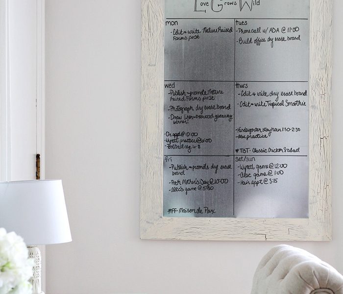 Get organized with this DIY Framed Dry Erase Board! It's simple to make and magnetic too! Get the full tutorial at LoveGrowsWild.com