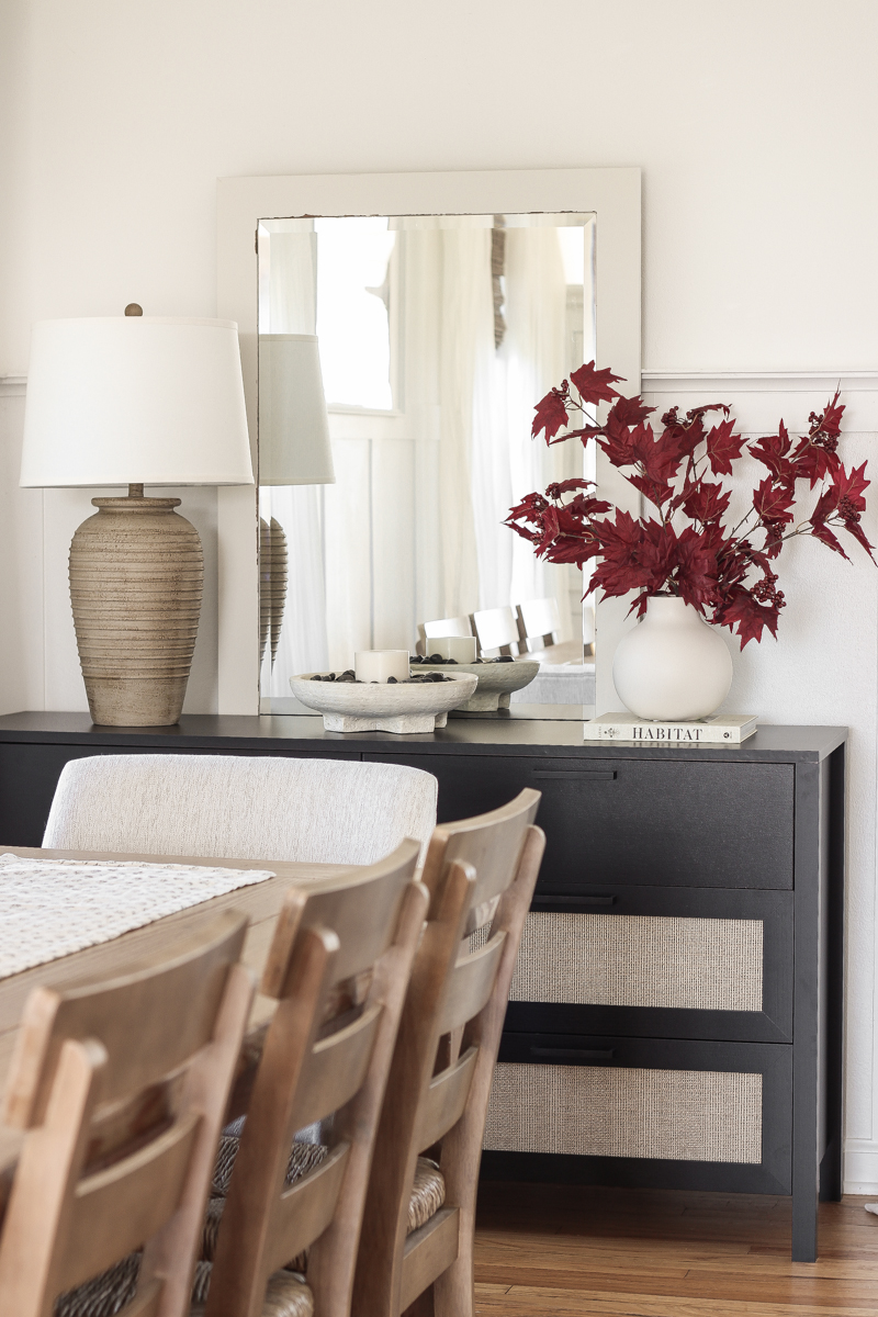 Home blogger and interior decorator Liz Fourez shares a beautiful fall vignette in her dining room featuring deep red fall branches and a new furniture find that has a high-end look without the high-end price