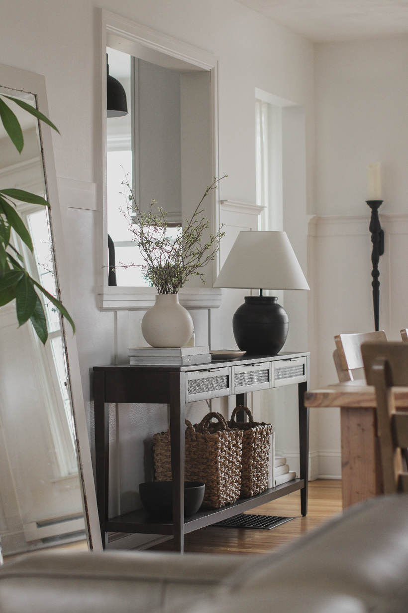 A beautiful dark wood console table styled in the home of blogger and interior decorator Liz Fourez