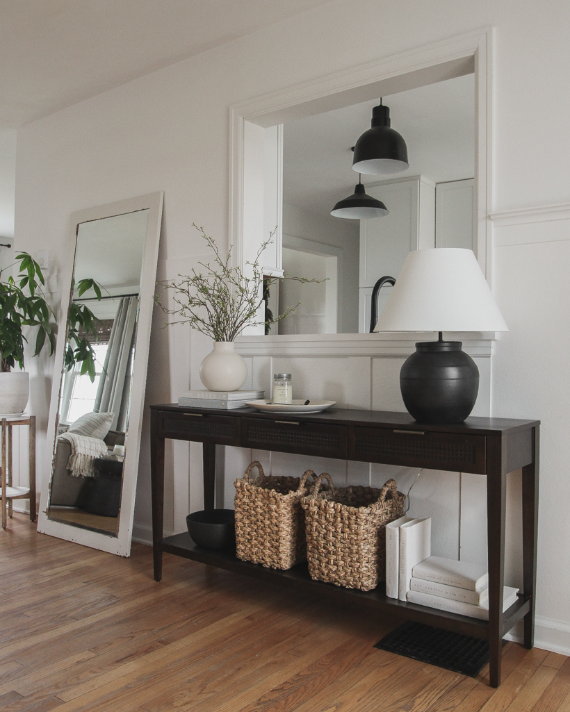 A beautiful dark wood console table styled in the home of blogger and interior decorator Liz Fourez