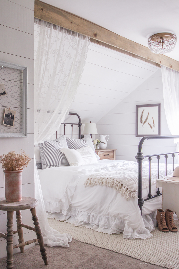 A clean and cozy farmhouse master bedroom with tons of vintage charm