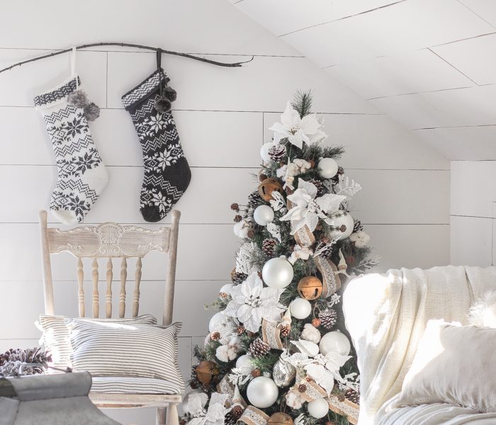 This cozy master bedroom is beautifully decorated for Christmas with soft neutrals and tons of farmhouse charm.